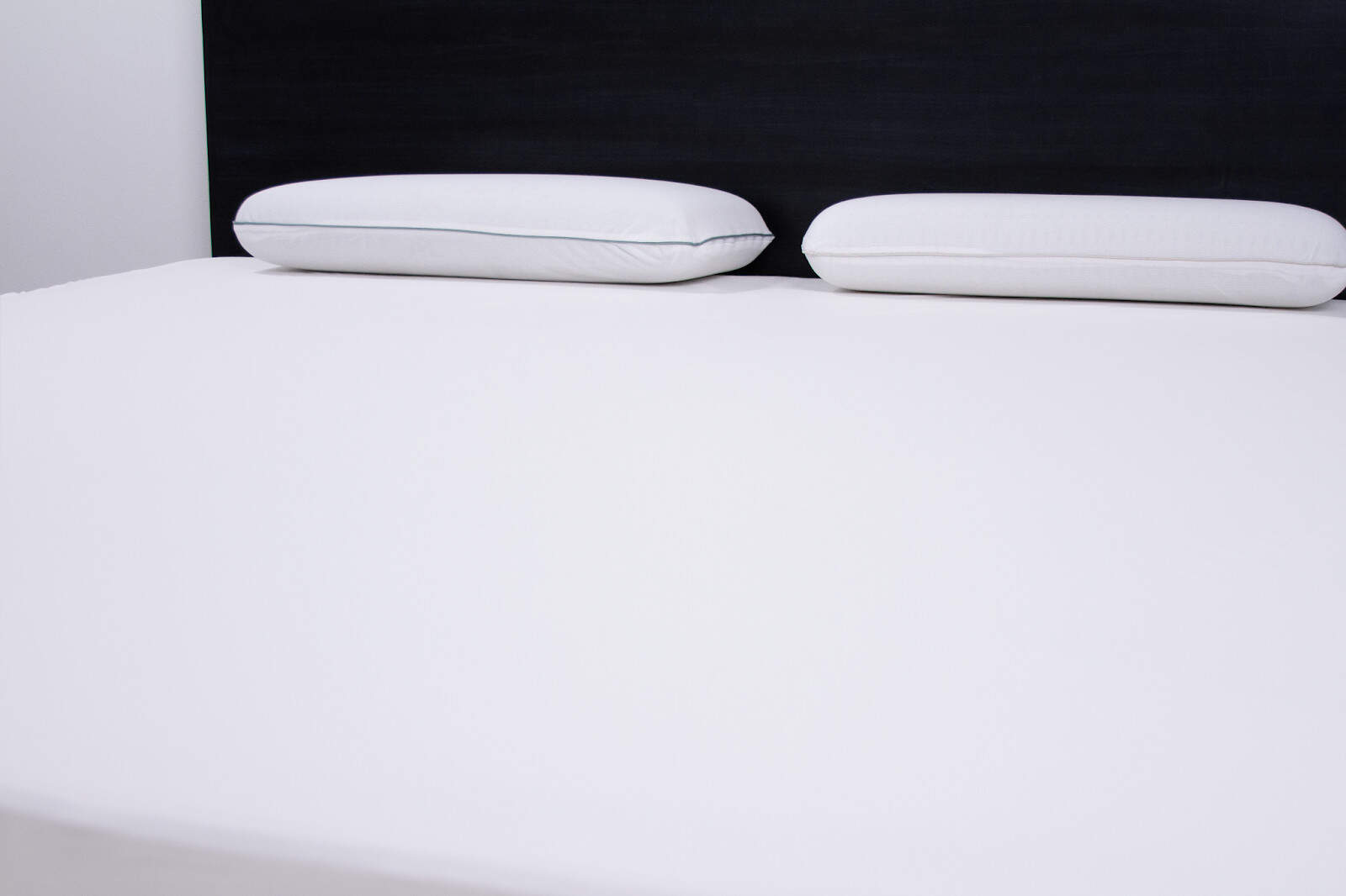 White bed sheets and pillows on bed.