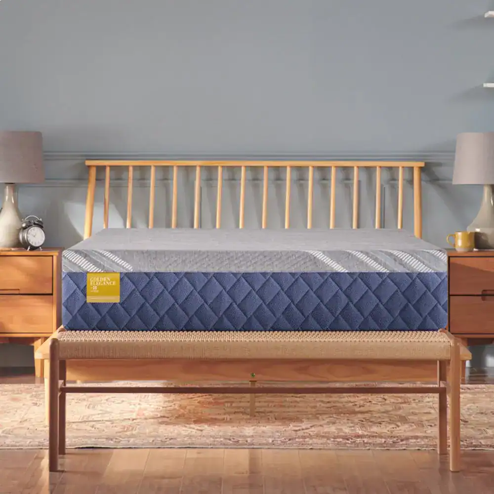 Wooden bed frame with blue mattress in styled bedroom.
