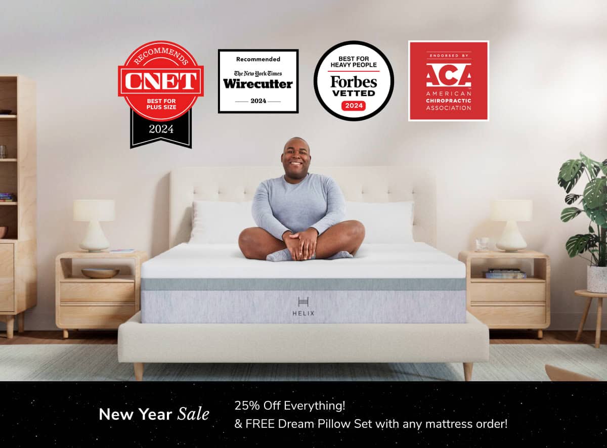 A person sits cross-legged and smiling on a bed with the HELIX Plus Mattress in a modern bedroom featuring wooden furniture. Logos for CNET, Wirecutter, Forbes Vetted, and ACA awards are above. A banner announces "New Year Sale: 25% Off Everything & FREE Dream Pillow Set.