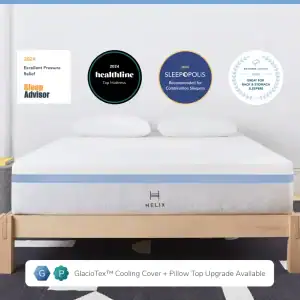 A neatly presented Helix Moonlight mattress showcased in a clean, minimalistic bedroom setting, featuring accolades from various reviewers such as sleep advisor, healthline, and sleepopolis, highlighting awards