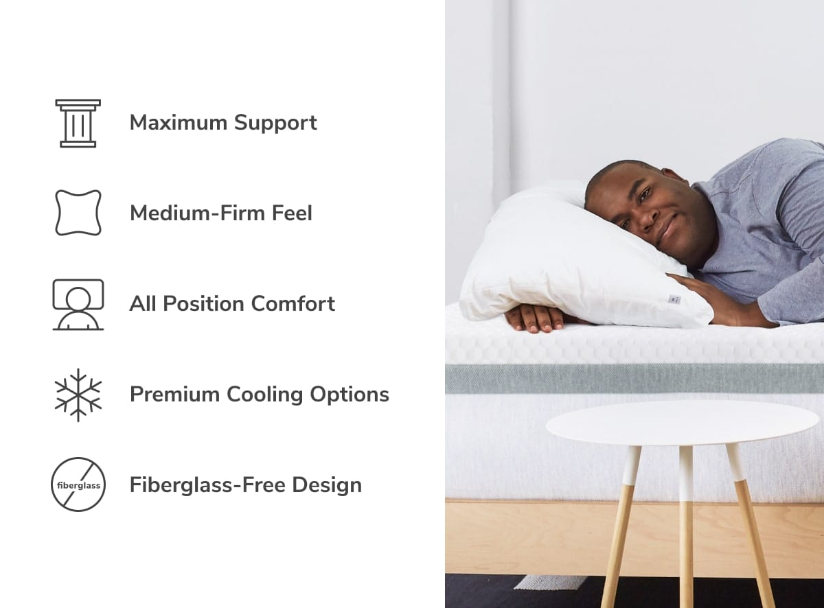 A person lies smiling on a bed, holding a pillow next to icons and text showcasing HELIX Plus Mattress features: Maximum Support, Medium-Firm Feel, Comfort for All Positions, Premium Cooling Options, and Fiberglass-Free Design. A small table sits in the foreground.