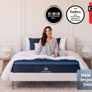 A smiling woman sits on a neatly made bed with a Brooklyn Signature Hybrid Mattress in a modern bedroom. Award badges from Wired, Forbes, and CNET are shown above with a "New and Improved Design" label in the corner.