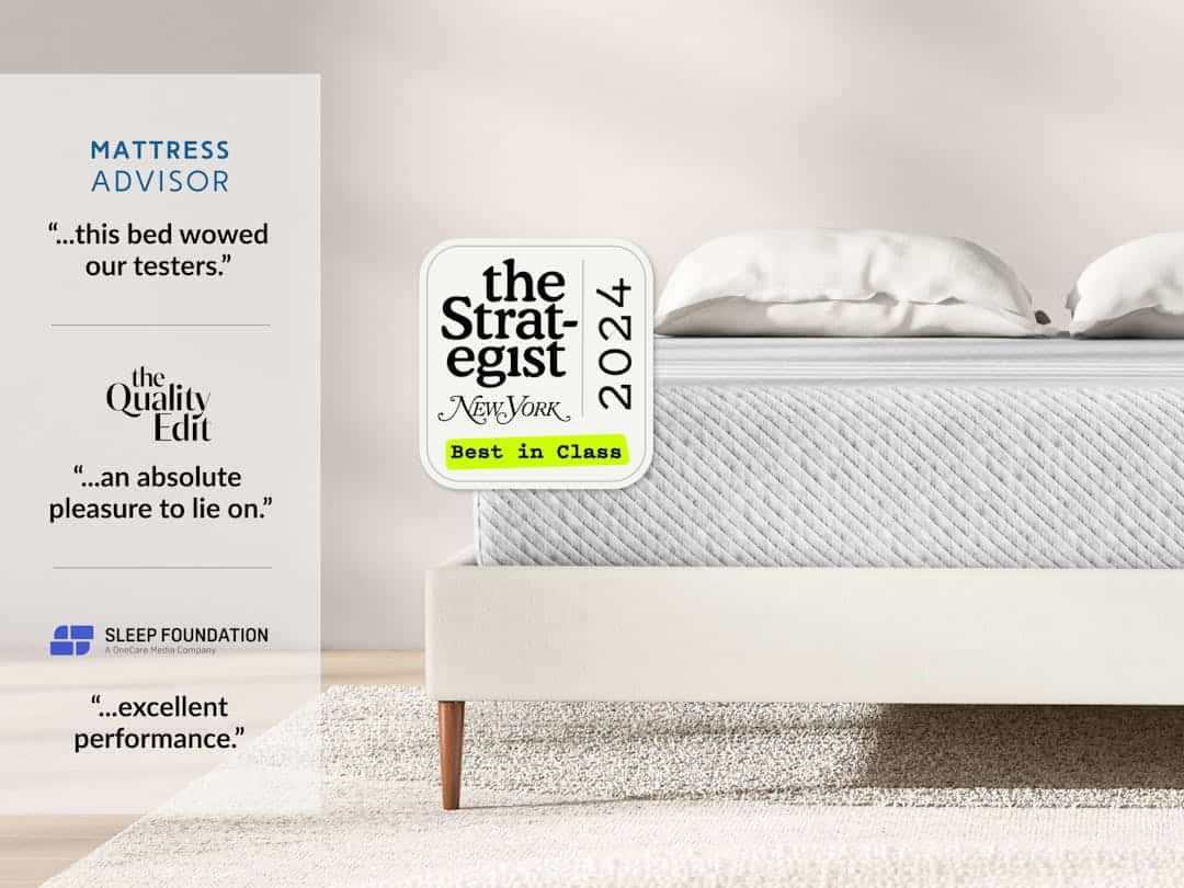 A minimalist bedroom features a neatly made bed with a white Original Hybrid Mattress and light grey quilted cover. Accolades from Mattress Advisor, The Quality Edit, and Sleep Foundation are displayed, highlighting praise for the bed's comfort and performance.