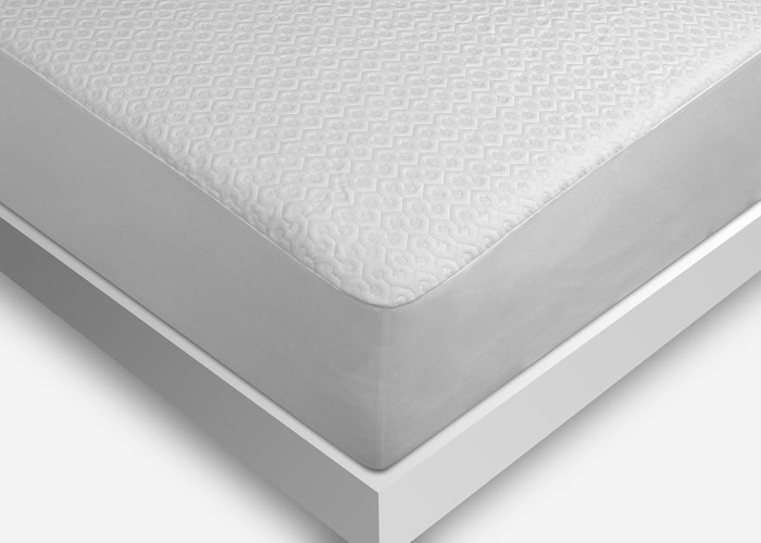 The image showcases a close-up of a neatly made bed with a white mattress on a modern, minimalist white bed frame. The mattress surface features a subtle, textured pattern that adds elegance to the clean design. Protected by the Dri-Tec Mattress Protector, the bed is positioned against a white background.