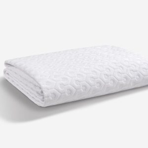 A neatly folded, white Dri-Tec Mattress Protector featuring a raised hexagonal pattern rests on a clean, white surface. Subtle shadows highlight its texture, making it an elegant addition to any bedding ensemble.