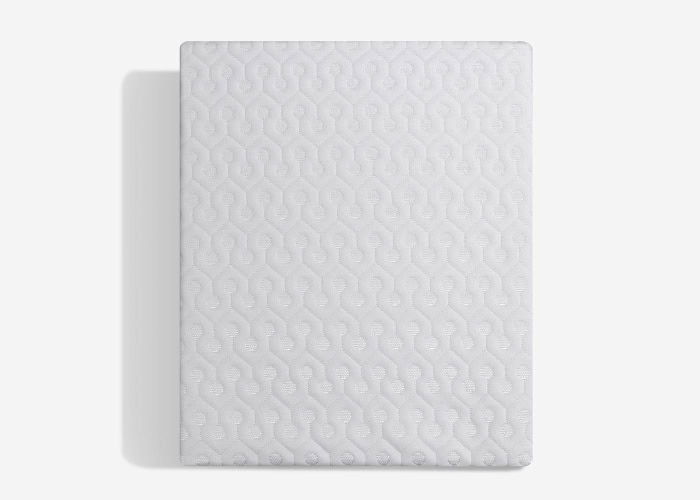The Dri-Tec Mattress Protector features a rectangular shape and a white surface adorned with a symmetrically interlocking wave pattern. It's displayed against a plain, light gray background with a subtle shadow cast to the left side.
