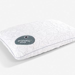 A white Storm Performance® Pillow, adorned with embossed geometric patterns, rests on a light-colored surface. In the corner of the pillow, there's a small circular patch displaying the text "STORM 0.0." The overall design of the pillow is minimalist and modern.