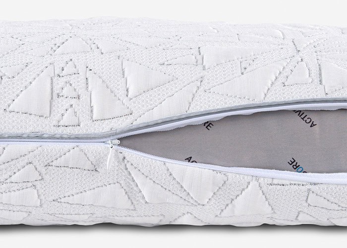 Close-up image of the Storm Performance® Pillow shows its textured white cover adorned with geometric shapes. An open zipper reveals the inner material, which is labeled with the words "ACTIVE" and "CORE" on light gray fabric.