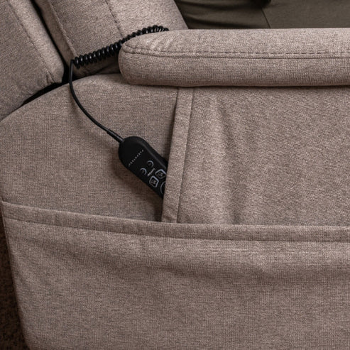 A close-up of the beige Zecliner Model 1 Power Sleep Chair shows its black remote—featuring visible buttons and a coiled cord—partially tucked into the side pocket.