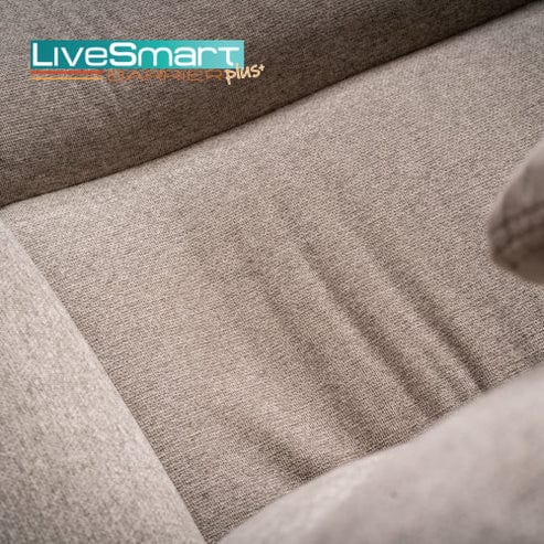 Close-up of a light beige upholstered cushion from the Model 2 Plus Power Lift Recliner, featuring the "LiveSmart Barrier Plus" logo in the top left corner. The soft fabric has a subtle texture.