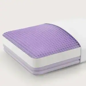 The Purple Free-Form Pillow, featuring a white cover and a purple, textured gel grid, is partially pulled from its pillowcase against a light background.