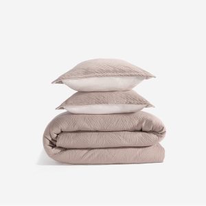 The Performance Duvet & Sham Set - Arrowhead in light taupe, featuring a subtle textured pattern, is neatly folded with two matching pillows against a plain white background for a stylish and cozy look.