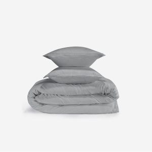 A neatly folded Performance Duvet & Sham Set - Solid in light gray, with two matching gray shams stacked on top, displayed against a plain white background.
