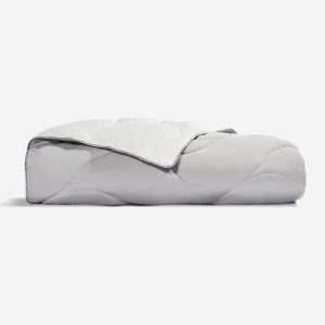 The Cooling Performance Throw Blanket in light gray, quilted and neatly folded, is displayed on a plain white background.