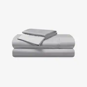 A neatly folded set of light gray Hyper - Cotton Performance Sheets, including two pillowcases, a flat sheet, and a fitted sheet, displayed against a plain white background.