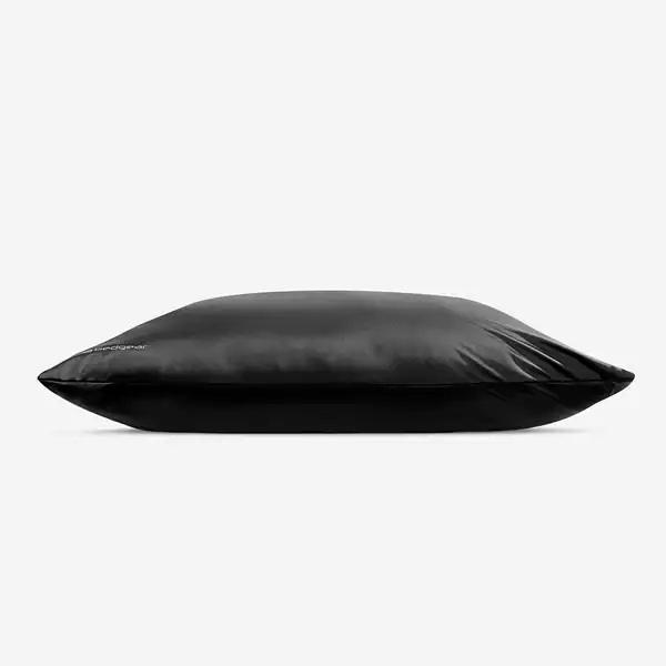 A soft black rectangular pillow, shown from the side against a white background, features the smooth and shiny Hyper Silk Performance Pillowcase.