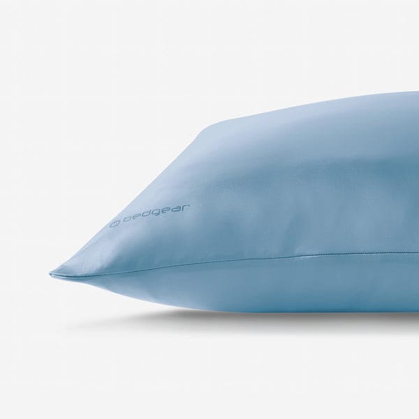 A light blue pillow in a smooth Hyper Silk Performance Pillowcase with the "bedgear" logo is displayed against a plain white background.